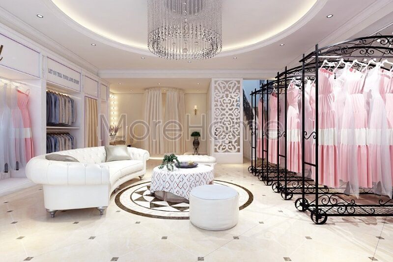 Thiết kế nội thất showroom áo cưới Calla Lily sang trọng với sự có mặt của bộ sofa da màu trắng cùng với thanh treo quần áo màu đen tạo điểm nhấn nổi bật cho không gian căn phòng